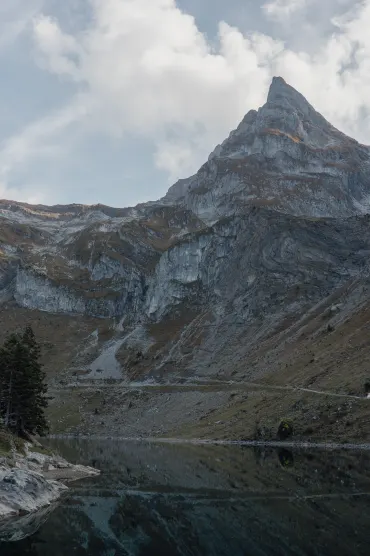 Explore the stunning alpine lake surrounded by majestic mountains in Wolfenschiessen, Switzerland.